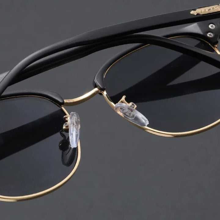 Classic Clubmaster half-frame sunglasses with a metal frame, UV400 lenses for eye protection.
