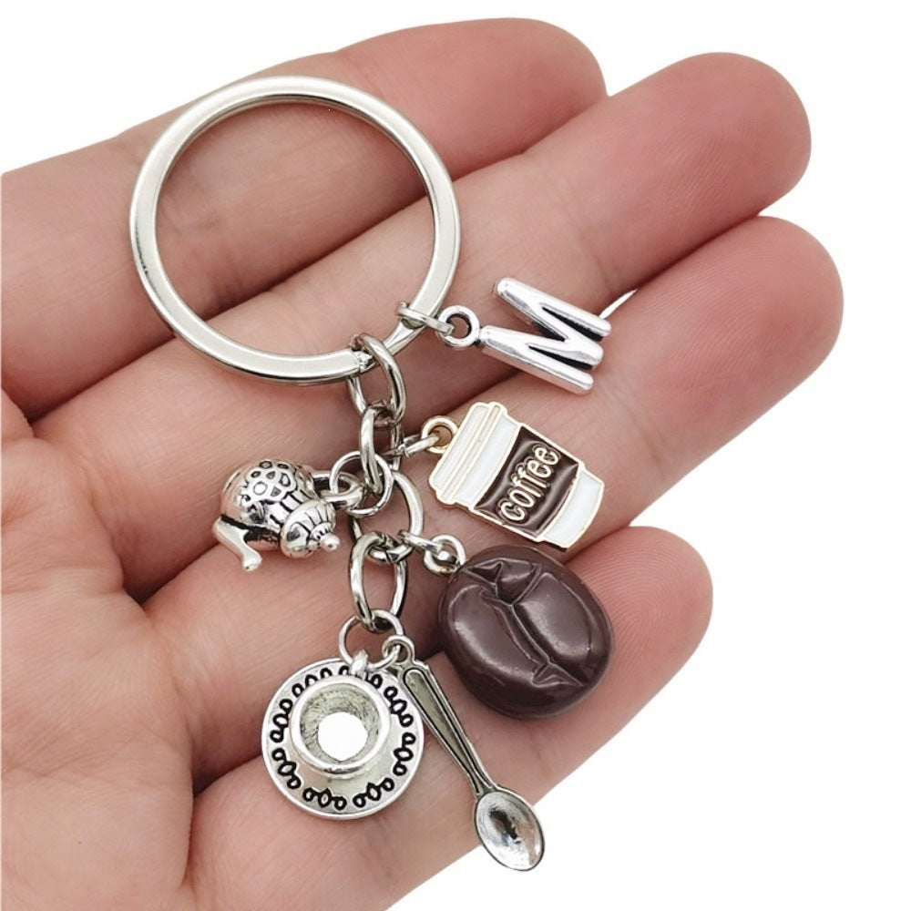 Unisex coffee lover charm keychain with whimsical coffee cup & snail. Ideal bag or key accessory & unique gift.