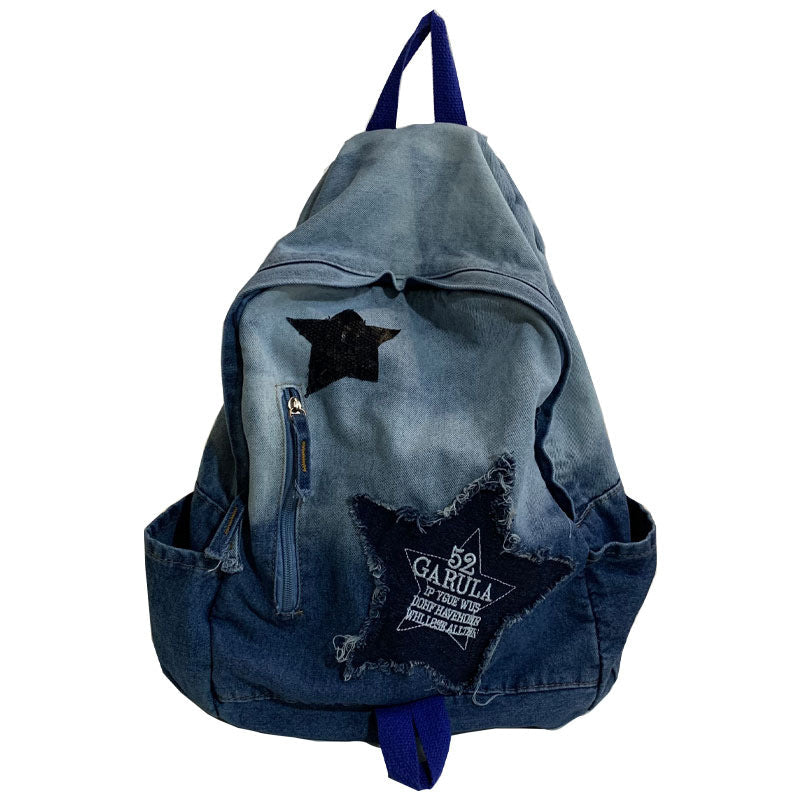 Unisex denim school backpack with star appliqué, padded straps, and multi-pockets for students and casual everyday use.
