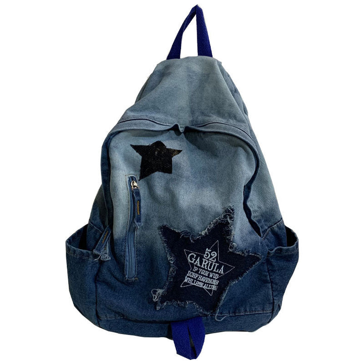 Unisex denim school backpack with star appliqué, padded straps, and multi-pockets for students and casual everyday use.