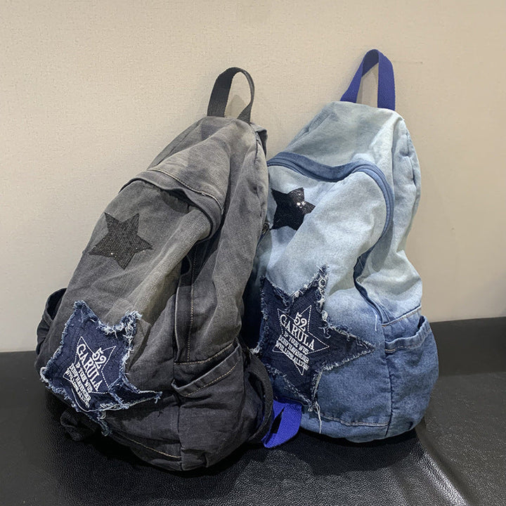 Durable unisex student denim backpack with star appliqué, multi-pockets, and padded straps for school or travel.