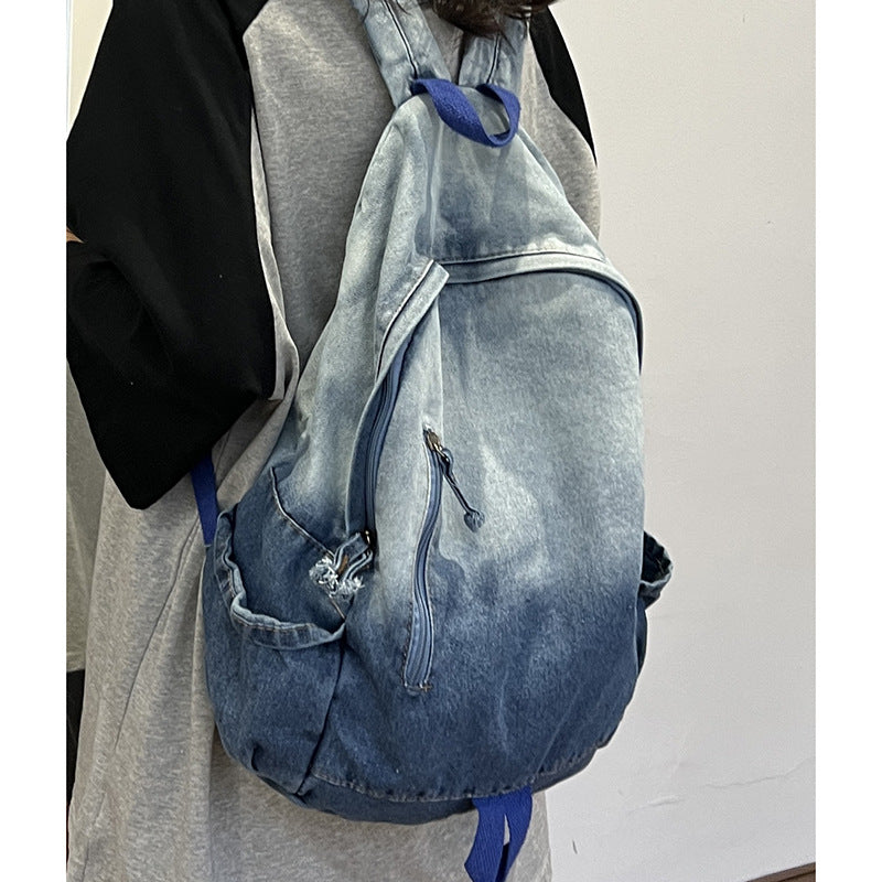 Versatile unisex denim backpack with star appliqué, spacious multi-pockets, ideal as a school bag or travel pack.