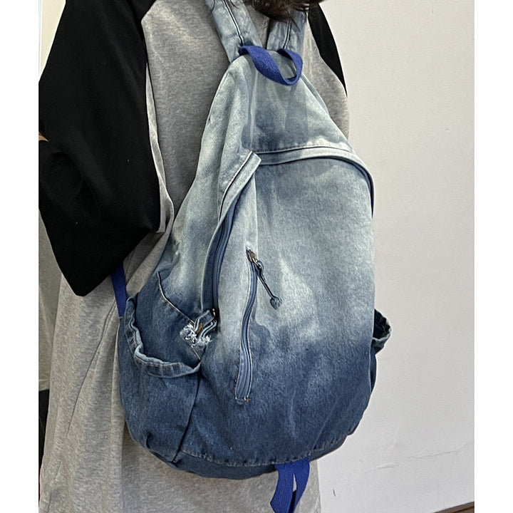 Versatile unisex denim backpack with star appliqué, spacious multi-pockets, ideal as a school bag or travel pack.