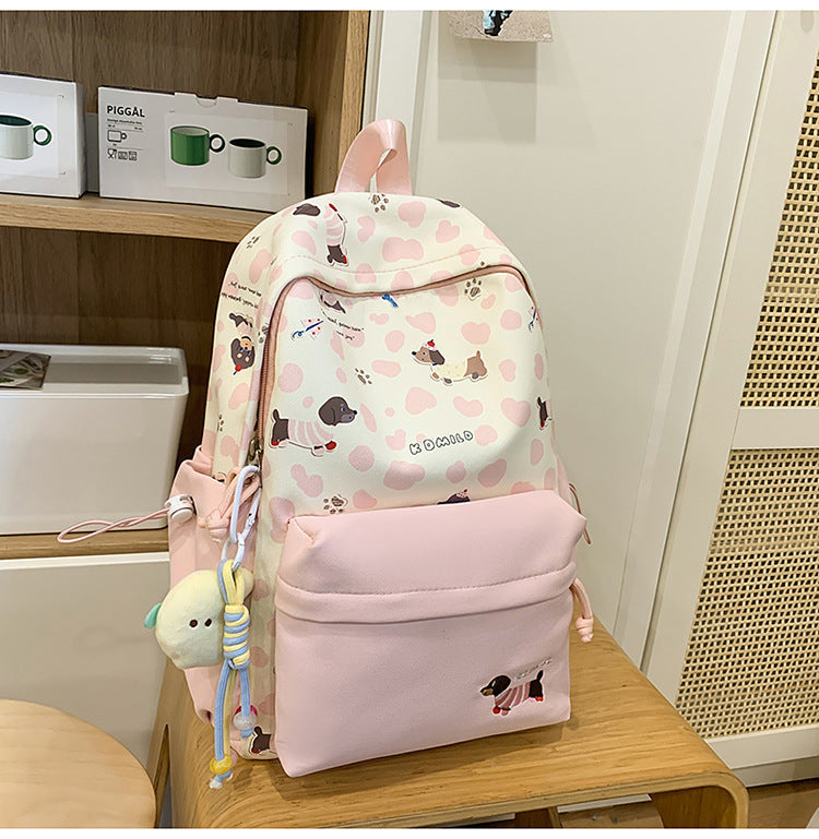 Unisex dog lover graphic backpack with playful puppy print, perfect for school or travel. Durable everyday bag.
