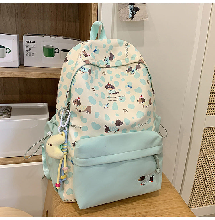 Cute dog print graphic backpack for pet lovers. Adjustable straps, ideal school bag or travel companion.