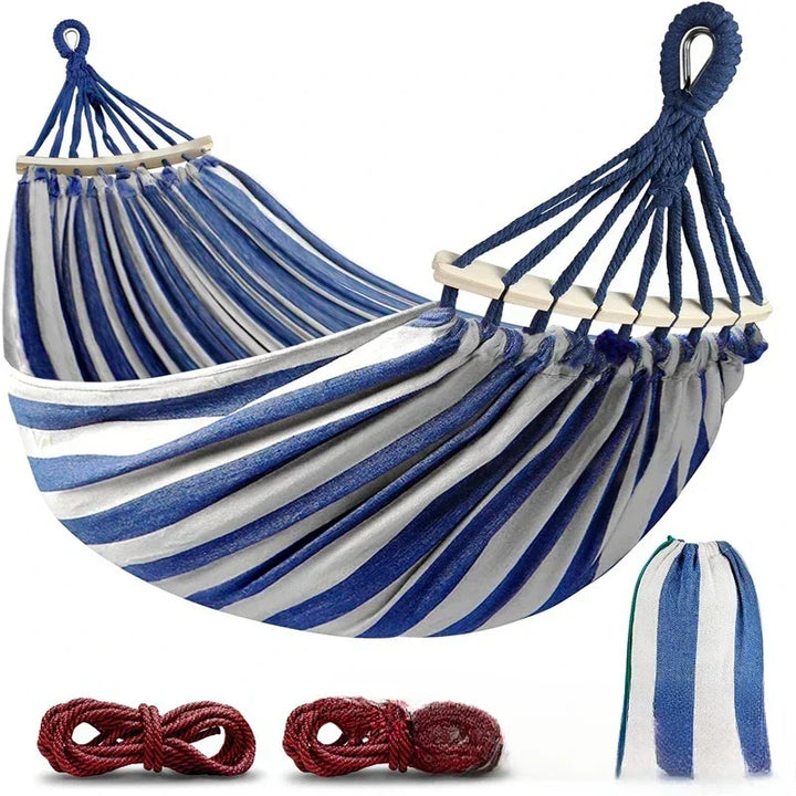 Unisex double canvas hammock with wooden spreaders, perfect for outdoor garden or patio relaxation.
