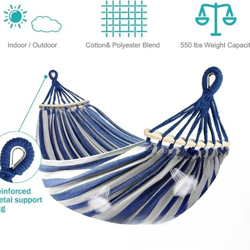 Comfortable double canvas hammock with sturdy wooden spreaders, ideal for outdoor garden and patio relaxation.