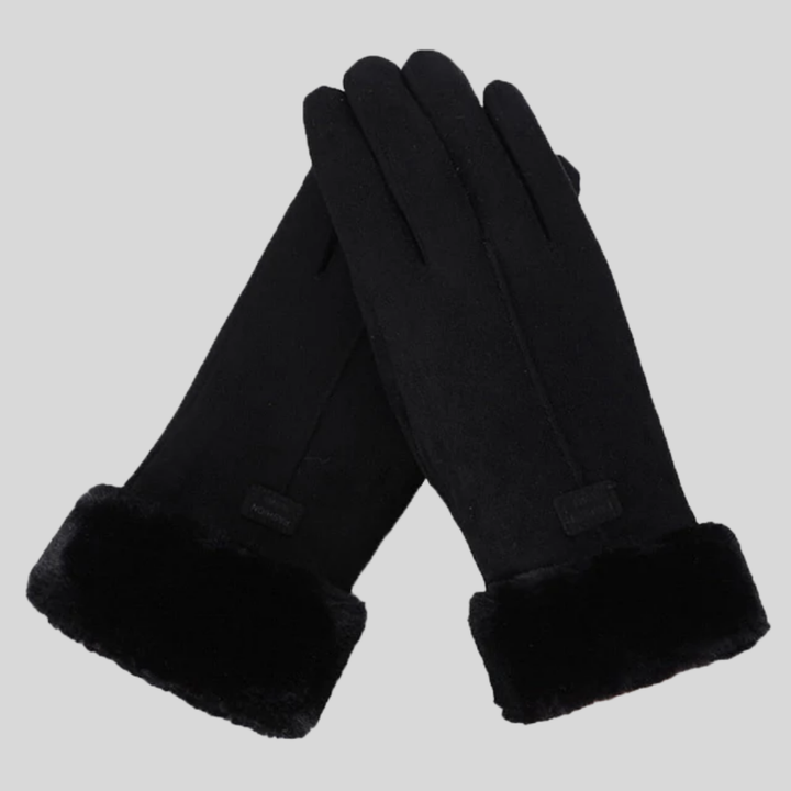 Person wearing durable unisex winter gloves while hiking in snow, ideal for cold weather outdoor activities.