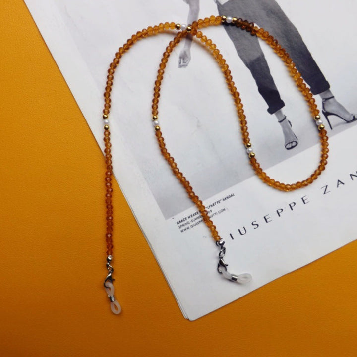 Elegant gold chain for glasses, a unisex accessory to prevent slipping or loss.