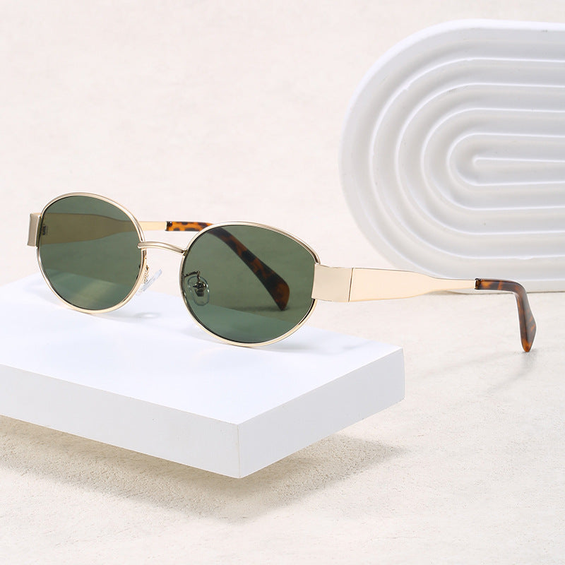 Unisex elegant oval sunglasses with sleek metal frame. Stylish eyewear for fashion & UV eye protection.