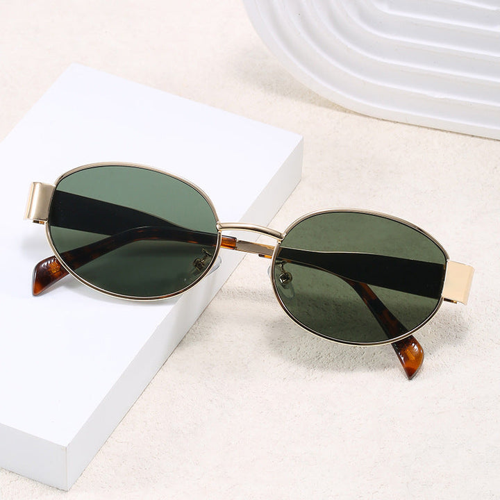 Chic unisex oval metal frame sunglasses. Modern design, UV protection eyewear. A stylish fashion accessory.