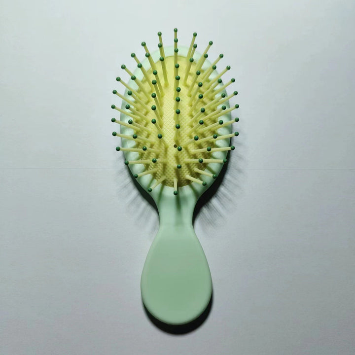 Straightening paddle brush with ergonomic grip for healthy & shiny, tangle-free hair.