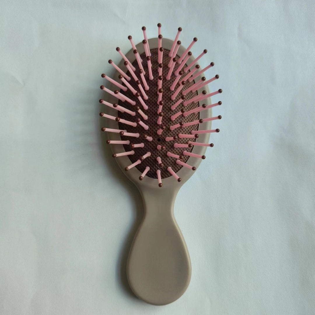 Styling tool: ergonomic detangling brush for straightening & frizz control.