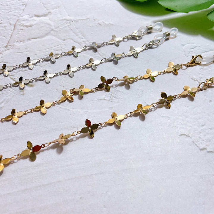 Fashionable gold-tone glasses chain with charming flower pendants. Practical spectacle holder & elegant accessory.