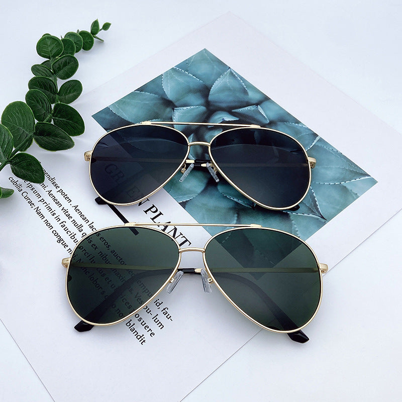 Stylish unisex aviator sunglasses, gold frame, dark lenses; fashion eyewear offering excellent UV protection.