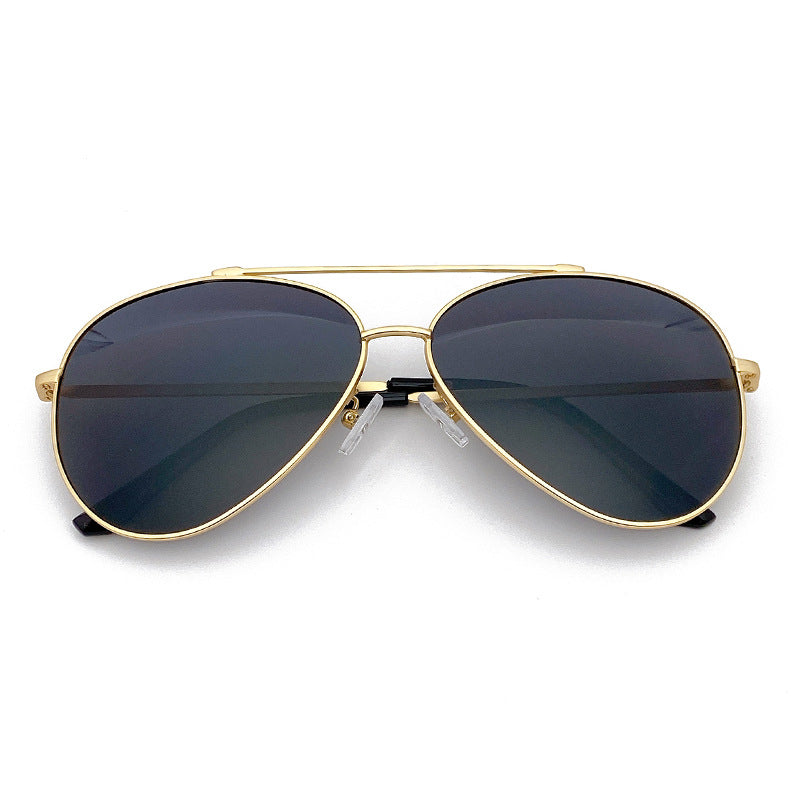 Gold frame pilot sunglasses, dark lenses; perfect unisex fashion shades for summer UV eye protection.