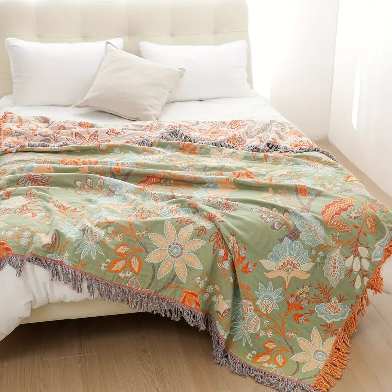 Decorative floral boho throw blanket with intricate patterns & fringe, made from a soft cotton blend for rustic style.
