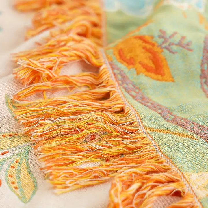 Fringed floral boho blanket in a cotton blend, adding bohemian style and rustic decor to any living space.