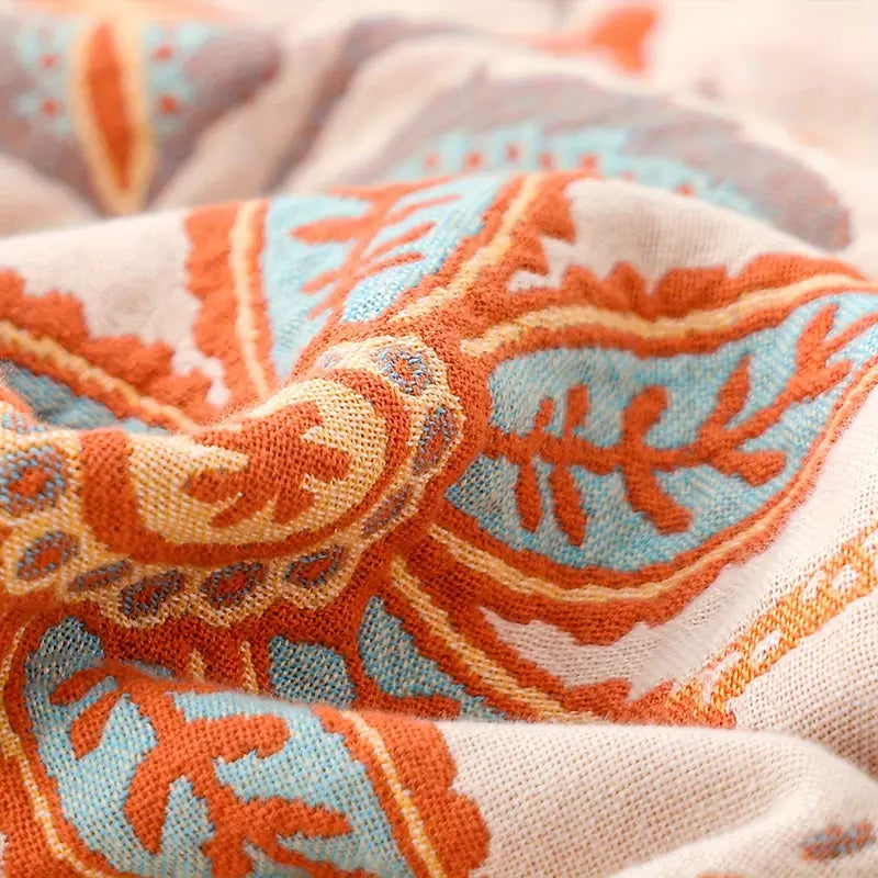 Vibrant floral boho throw blanket, a soft cotton blend home accessory bringing cozy comfort and bohemian style.