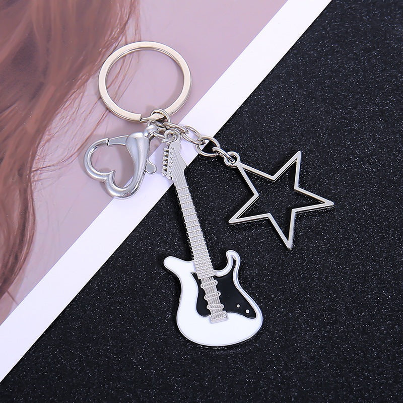 Versatile unisex guitar key holder, great as a bag charm, car key holder or music accessory.