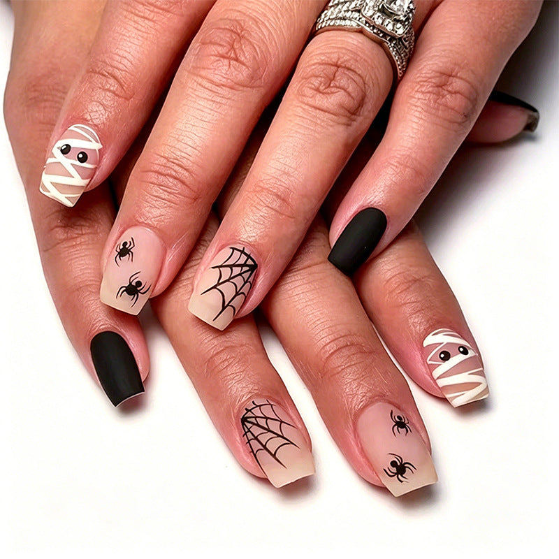 Unisex Halloween nail art kit with assorted spooky designs like ghosts, pumpkins & spiders for festive fun.