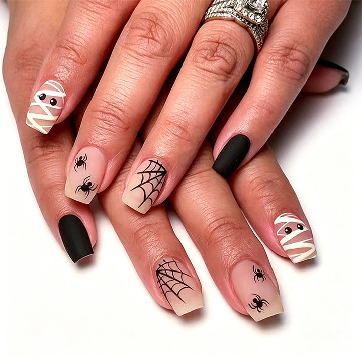 Unisex Halloween nail art kit with assorted spooky designs like ghosts, pumpkins & spiders for festive fun.