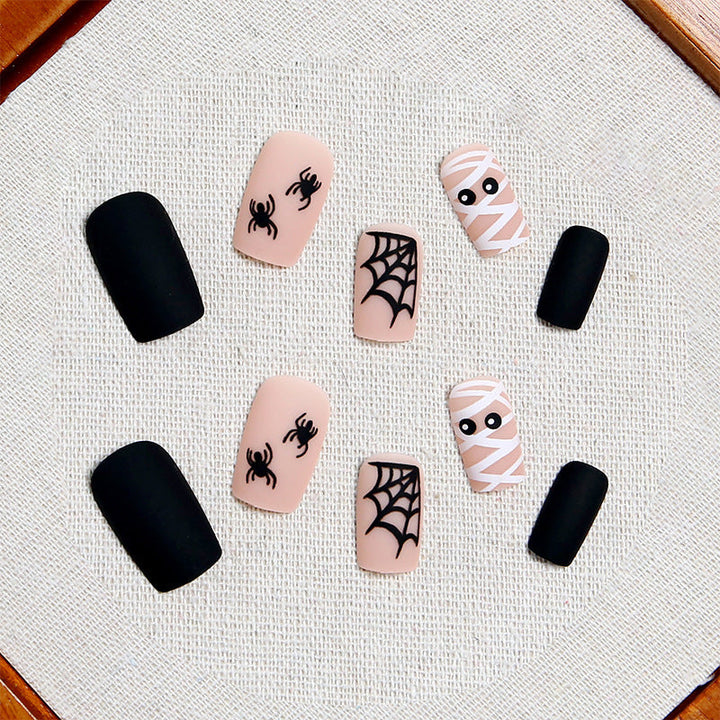 Easy-to-apply unisex Halloween press-on nails featuring spooky designs, perfect for a quick festive manicure.