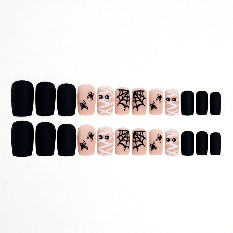 Variety of spooky Halloween nail art designs, including bats & webs, for a fun, festive unisex manicure.
