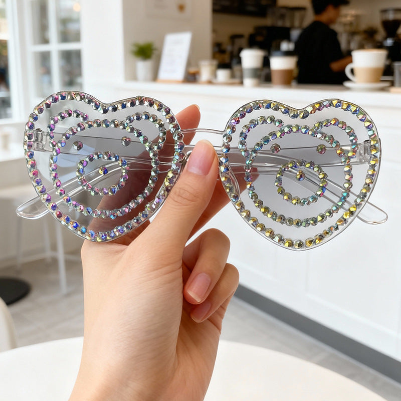 Rhinestone-embellished heart sunglasses, offering stylish UV protection & a trendy look.