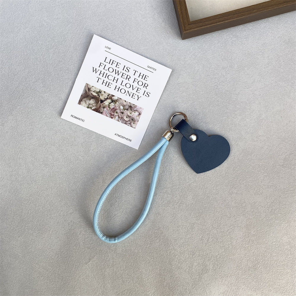 Fashionable heart leather keychain for keys or handbag decoration.