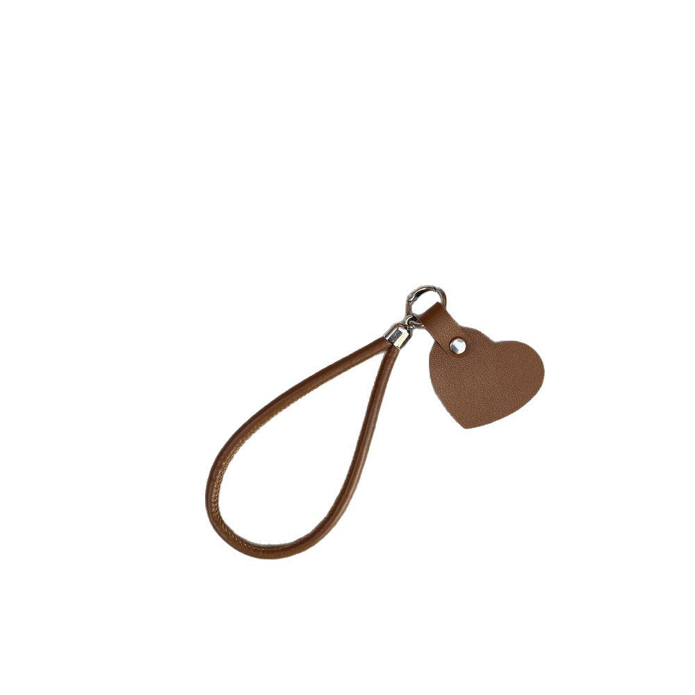 Vibrant red leather heart keychain, a colorful fashion accessory for bags & keys.
