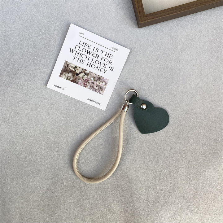 Sleek black leather heart bag charm, elegant & durable key accessory.