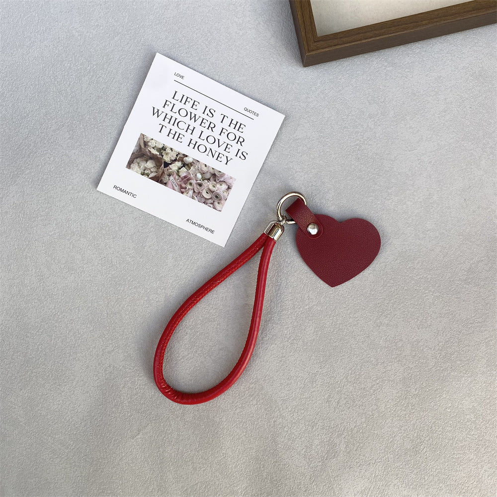 Charming pink leather heart keychain, cute accessory for bags & keys.