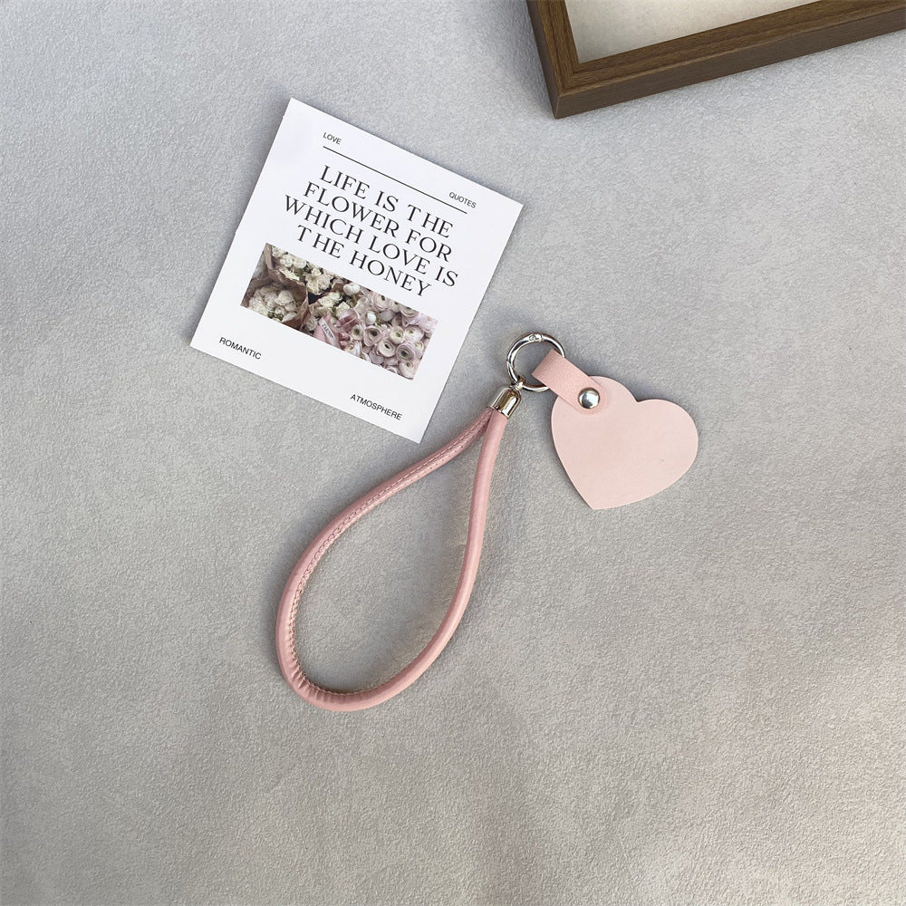 Close-up of a well-crafted leather heart key ring, a versatile unisex accessory.