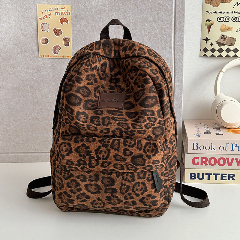 Unisex leopard print casual backpack for school, travel, or daily use. Stylish animal print fashion accessory.