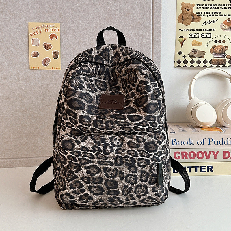 Casual leopard print travel backpack with spacious compartments, ideal for students or a fashionable daily bag.