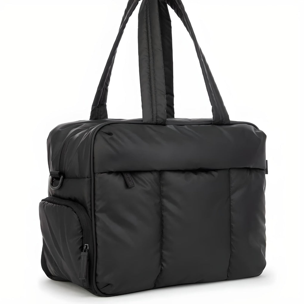 Unisex lightweight black puffer duffle bag for travel & gym. Spacious quilted design, perfect carry-on or weekend bag.