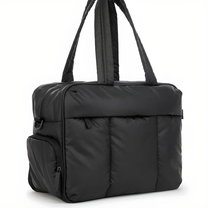Unisex lightweight black puffer duffle bag for travel & gym. Spacious quilted design, perfect carry-on or weekend bag.