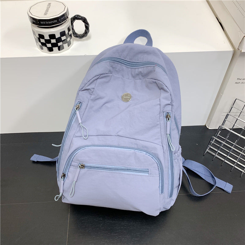 Unisex lightweight travel backpack in black, featuring a sleek design for multi-functional use. Ideal as a daypack.