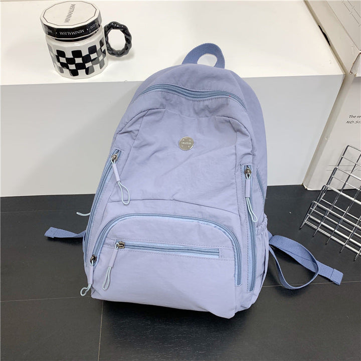 Unisex lightweight travel backpack in black, featuring a sleek design for multi-functional use. Ideal as a daypack.