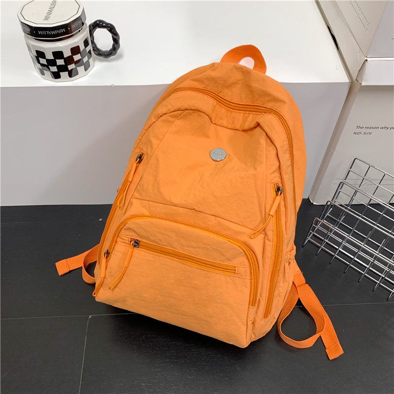 Spacious lightweight unisex travel backpack, perfect as a multi-functional daypack or school bag. Durable design.