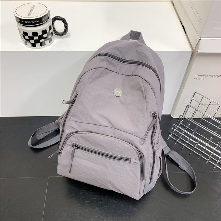 Multi-functional unisex travel backpack with ample storage, ideal for school, commuting, or outdoor adventures.