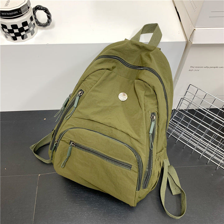 Durable, water-resistant fabric of a lightweight unisex travel backpack. Great multi-functional commuter or school bag.