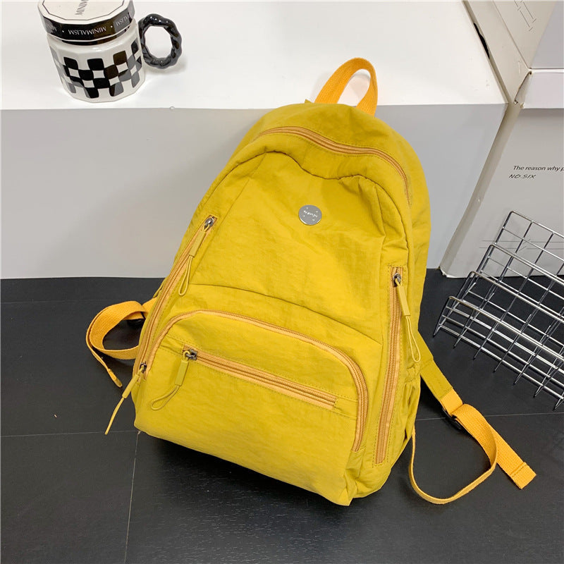 Lightweight multi-functional travel backpack for men & women, shown in an airport setting. Perfect daypack.