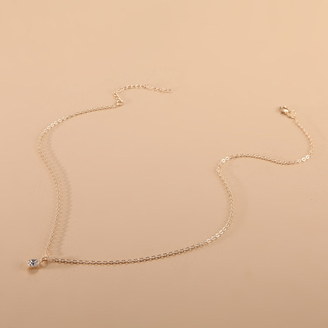 Close-up of a minimalist adjustable chain necklace, versatile unisex jewelry for layering or simple elegance.