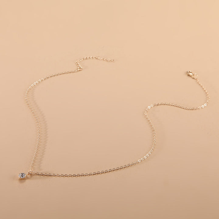 Close-up of a minimalist adjustable chain necklace, versatile unisex jewelry for layering or simple elegance.