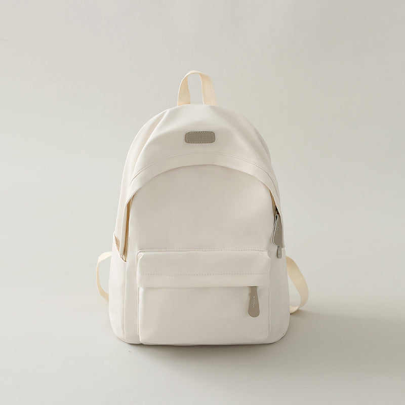 Unisex model wearing a stylish black minimalist backpack, suitable for office, university, or weekend trips.