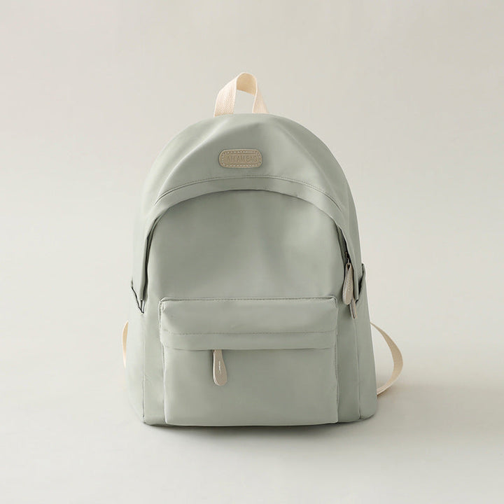 Side view of a functional black minimalist backpack, showcasing its clean lines and robust construction.