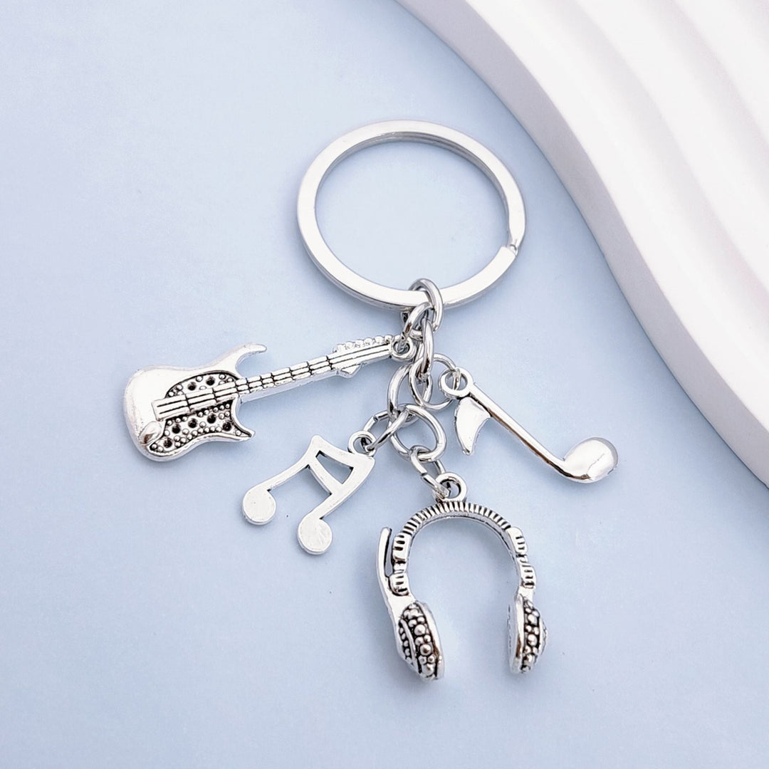 Unisex musical instrument keychain charm featuring various detailed music-themed designs for music lovers.