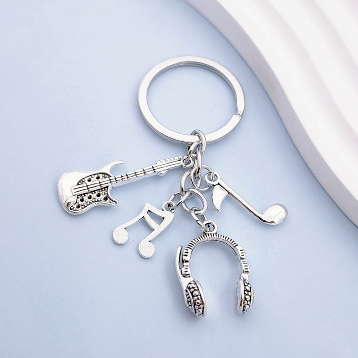 Unisex musical instrument keychain charm featuring various detailed music-themed designs for music lovers.